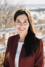 Photo of myself smiling with long hair and red blazer