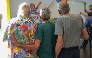 Three West of 50 members standing together at a Denver Art Museum event