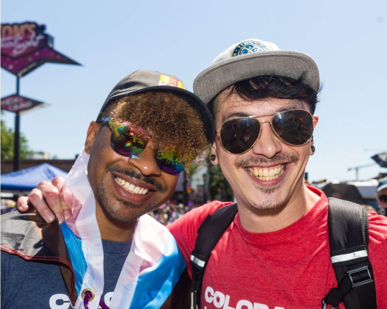 Two attendees of the Coors Light Denver Pride Parade smiling for a photo