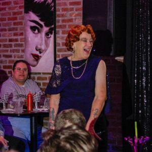 Avis Blankenship (she/her) performing in drag as Ava Blu at The Center's 2024 Schule of Drag