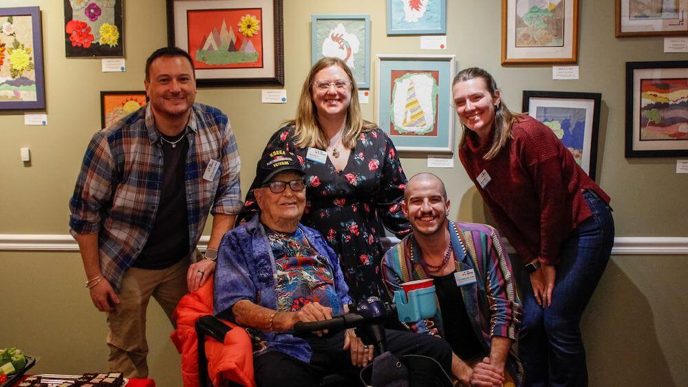 West of 50 member Ken Felts poses with West of 50 staff and interns during the Holiday Party and Art Show. Ken was this year's featured artist.