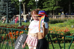 Two attendees pose for a photo as Denver Pride winds down for the weekend