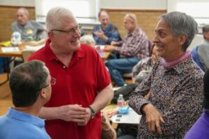 West of 50 members converse and smile together